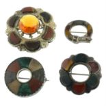 Four late 19th century hardstone brooches, to include a citrine and hardstone circle brooch.