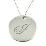 A monogrammed disc pendant, with ball chain, by Tiffany & Co.