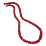 A coral single-strand necklace.