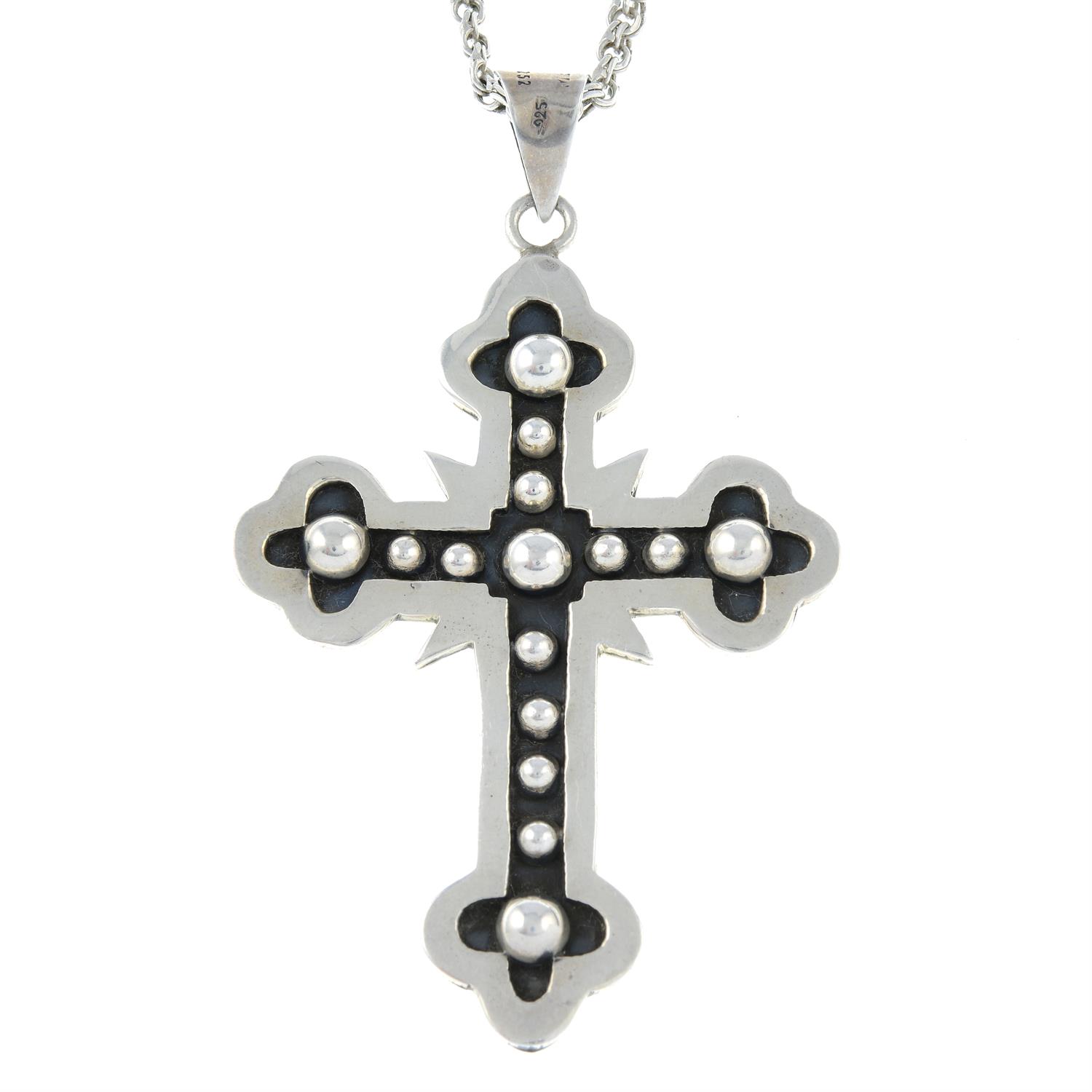 A cross pendant with chain.