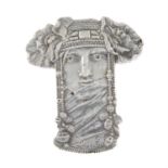 A silver brooch depicting an Art Nouveau-style woman's face with a beaded and floral headdress.