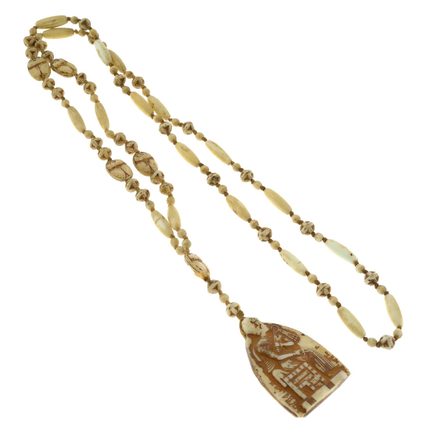 A carved bone bead necklace, with Egyptian iconography. - Image 2 of 2