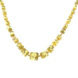 A mid 20th century graduated yellow foil paste bead necklace.