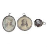 Three early to mid 20th century silver locket pendants.