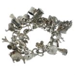 A silver charm bracelet suspending a heart-shaped padlock clasp with various charms.