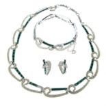 A colourless and green paste necklace, bracelet and clip-on earring set, by Marcel Boucher.