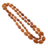 An amber oval bead single-strand woven necklace.