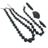 Two faceted jet bead necklaces, together with three further items.