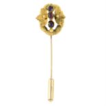 A late 19th century garnet three-stone stickpin, with fastening tip.