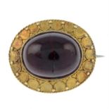 A late Victorian garnet cabochon brooch.