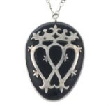 A late 19th century silver vulcanite luckenbooth pendant, on integral chain.