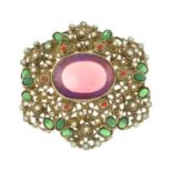A vari-coloured paste brooch, with iridescent central gem.