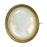 A mid 19th century gold white glass and agate cameo brooch, depicting a woman in profile.