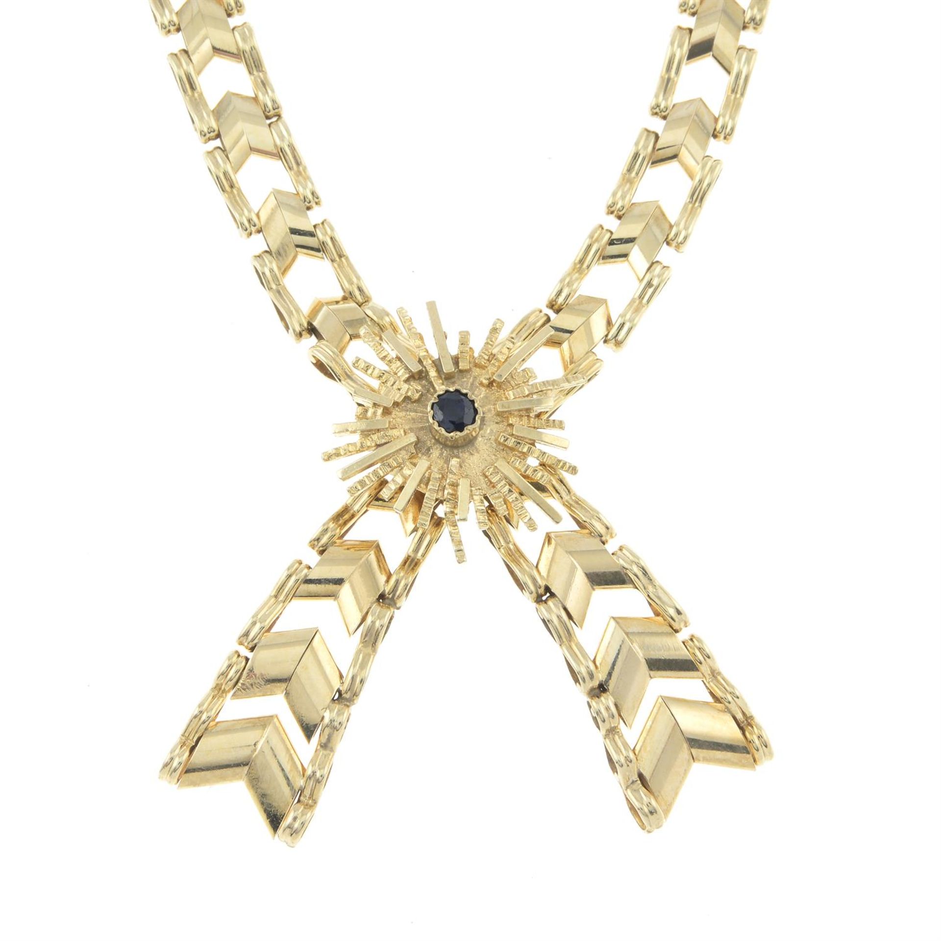 A 9ct gold fancy-link necklace, with sapphire highlight.