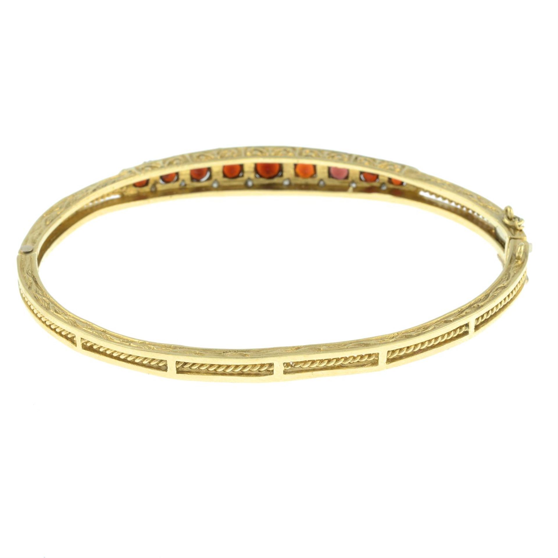 A 9ct gold garnet and diamond hinged bangle. - Image 2 of 2