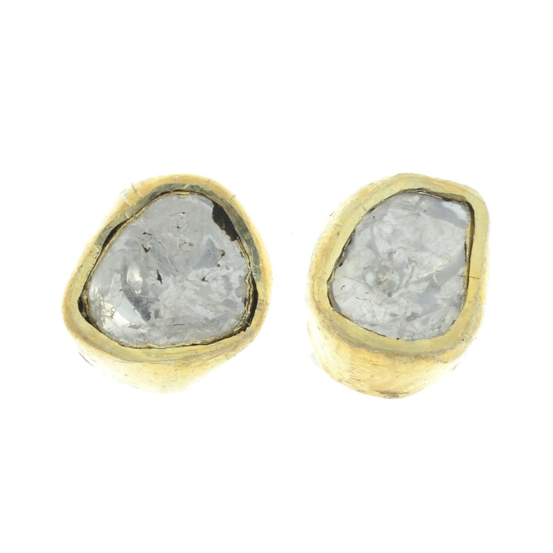A pair of polki diamond stud earrings.