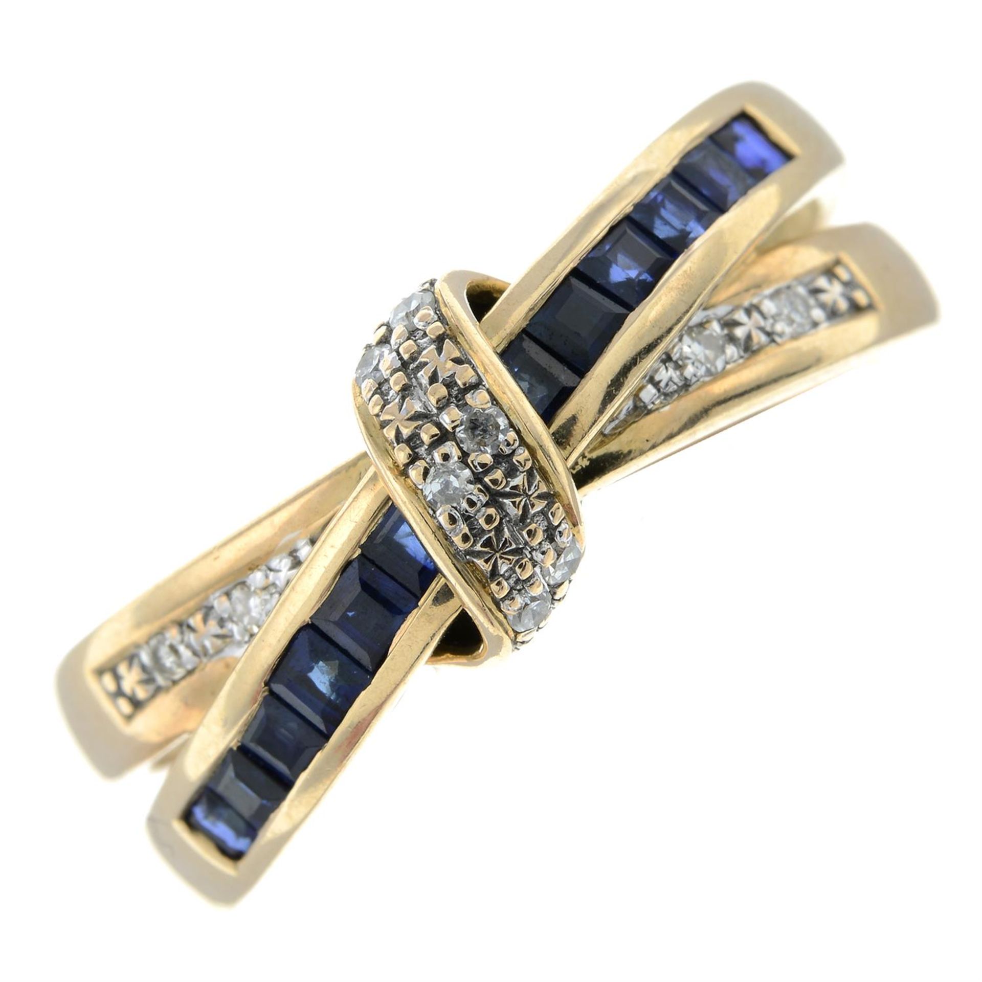 A 9ct gold calibre-cut sapphire and single-cut diamond crossover ring.