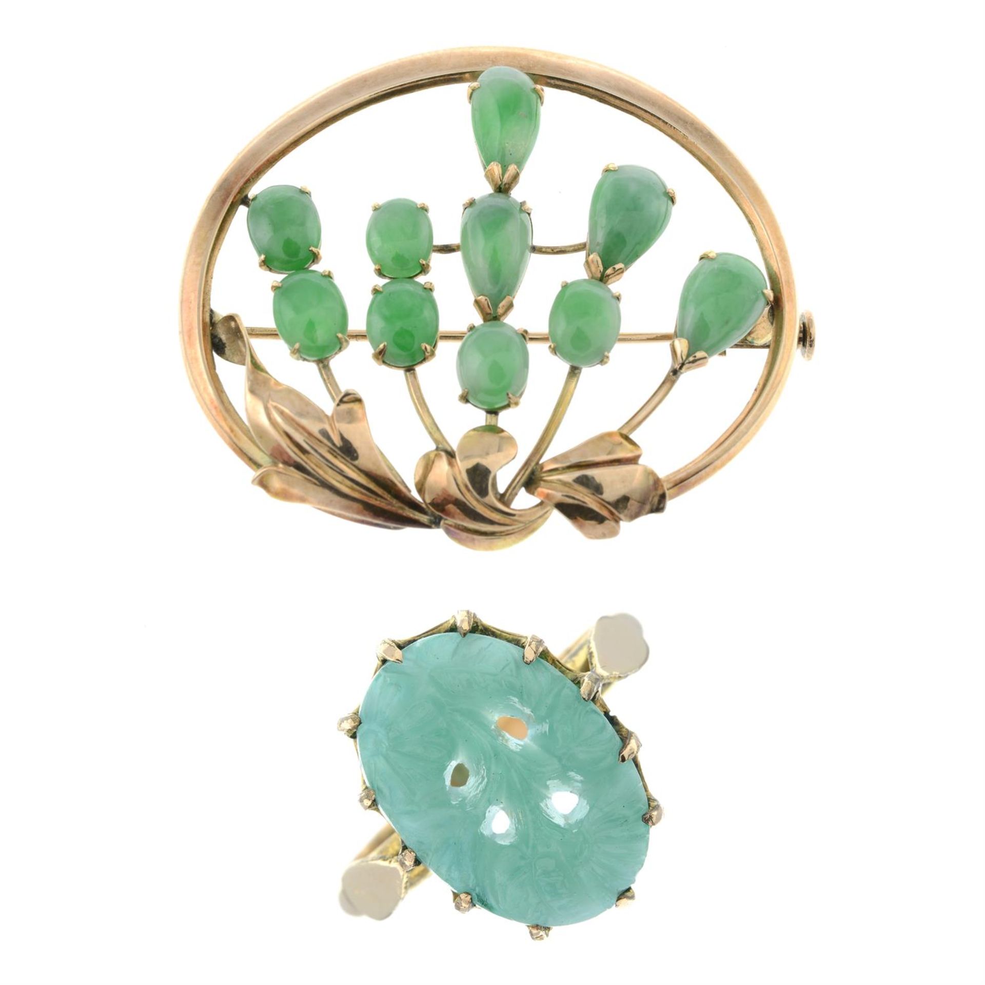 A jade floral brooch and a carved glass ring.