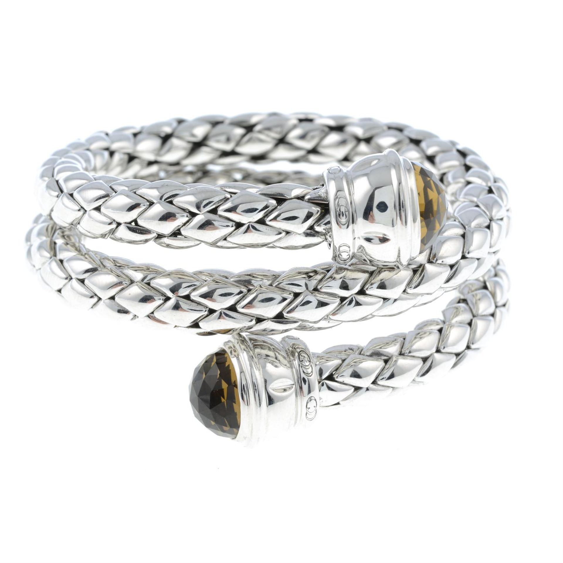 A silver bangle, with citrine terminals, by Chimento.