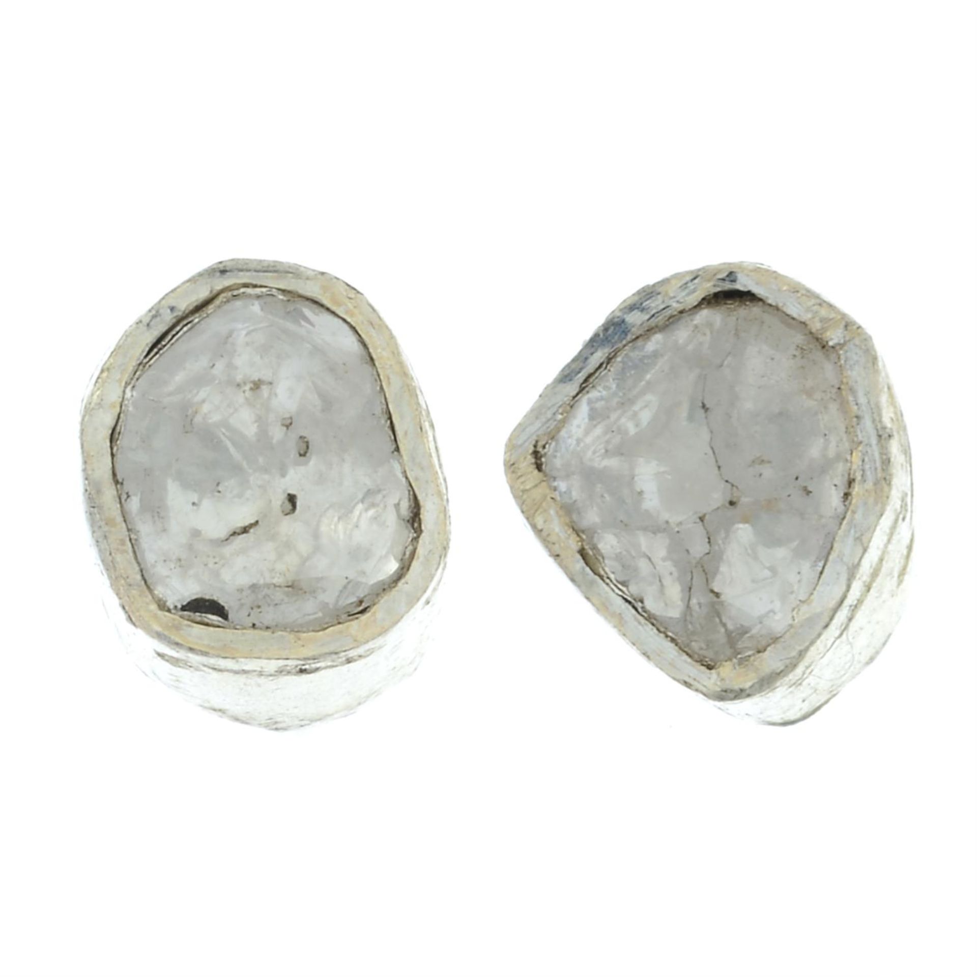 A pair of polki diamond stud earrings.