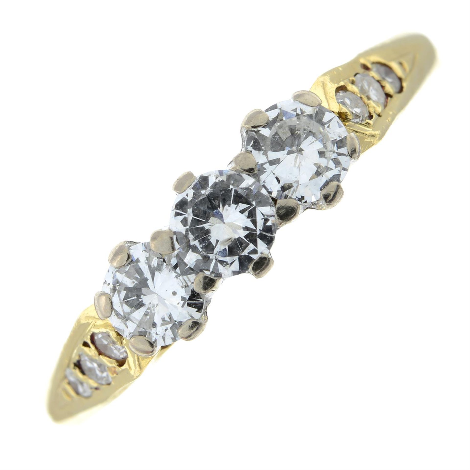 An 18ct gold brilliant-cut diamond three-stone ring, with single-cut diamond sides.