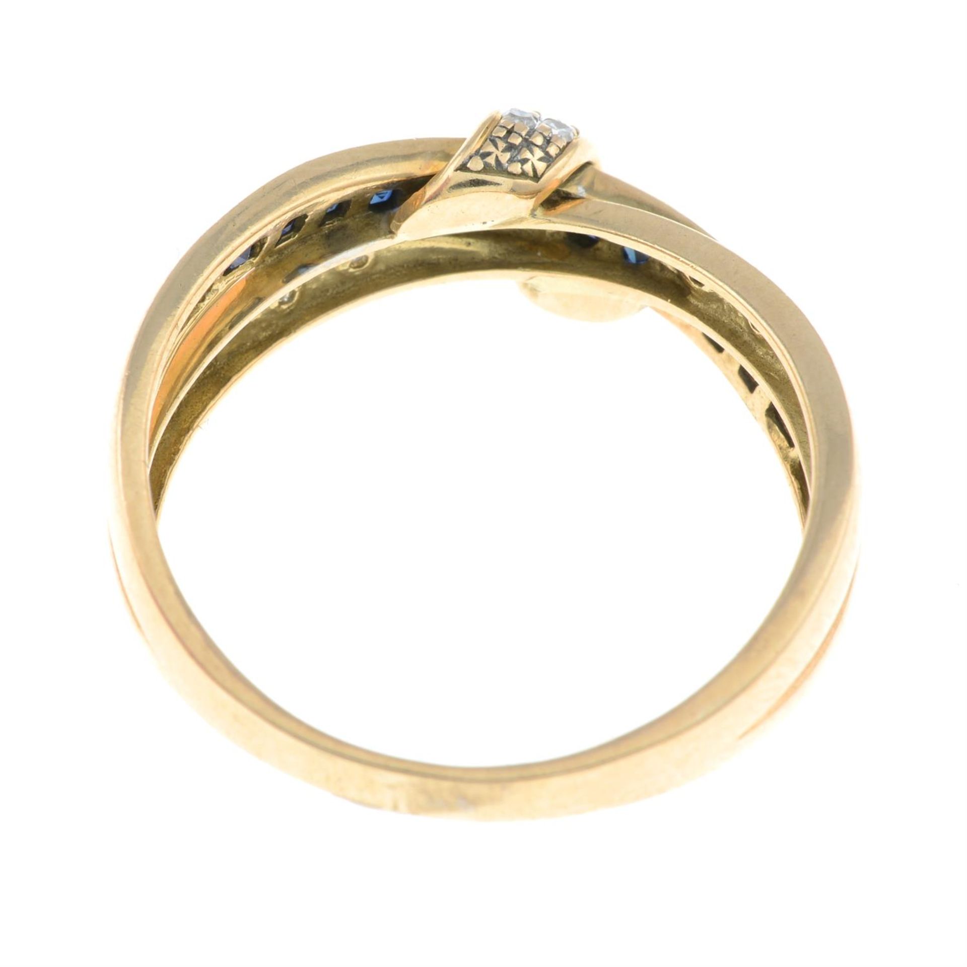 A 9ct gold calibre-cut sapphire and single-cut diamond crossover ring. - Image 2 of 2