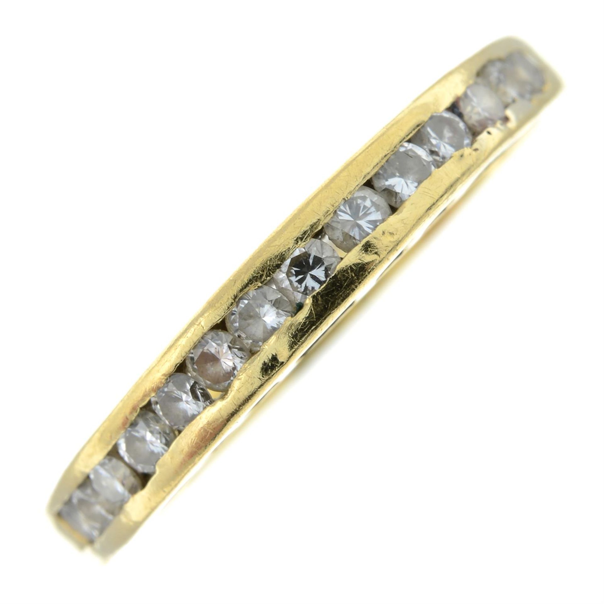 A brilliant-cut diamond half-eternity ring.