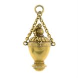 A late 19th century Etruscan Revival 15ct gold urn pendant.