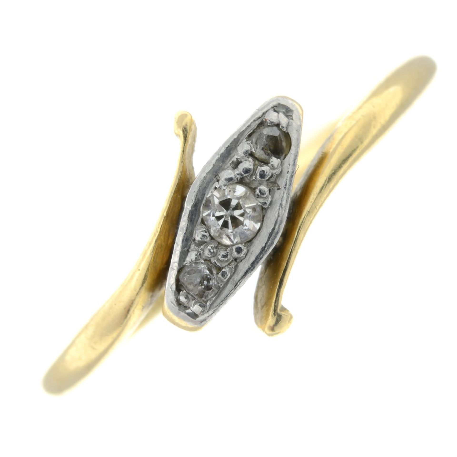 A mid 20th century 18ct gold diamond three-stone crossover ring.