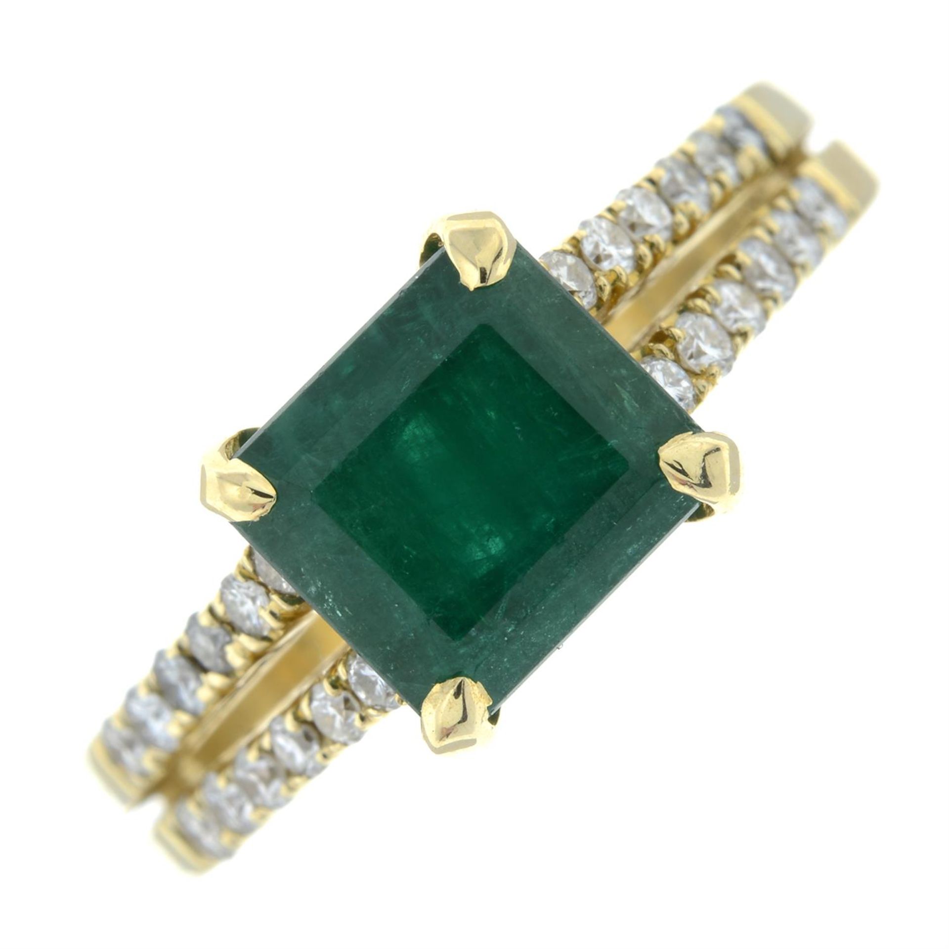 An emerald ring, with brilliant-cut diamond shoulders.