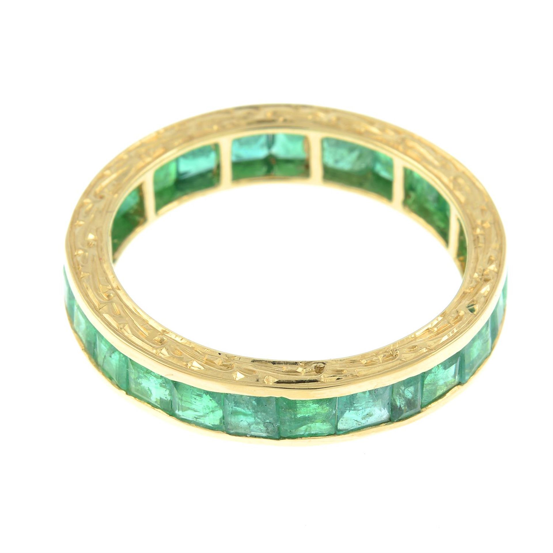 An emerald full eternity ring, with engraved sides. - Image 2 of 2