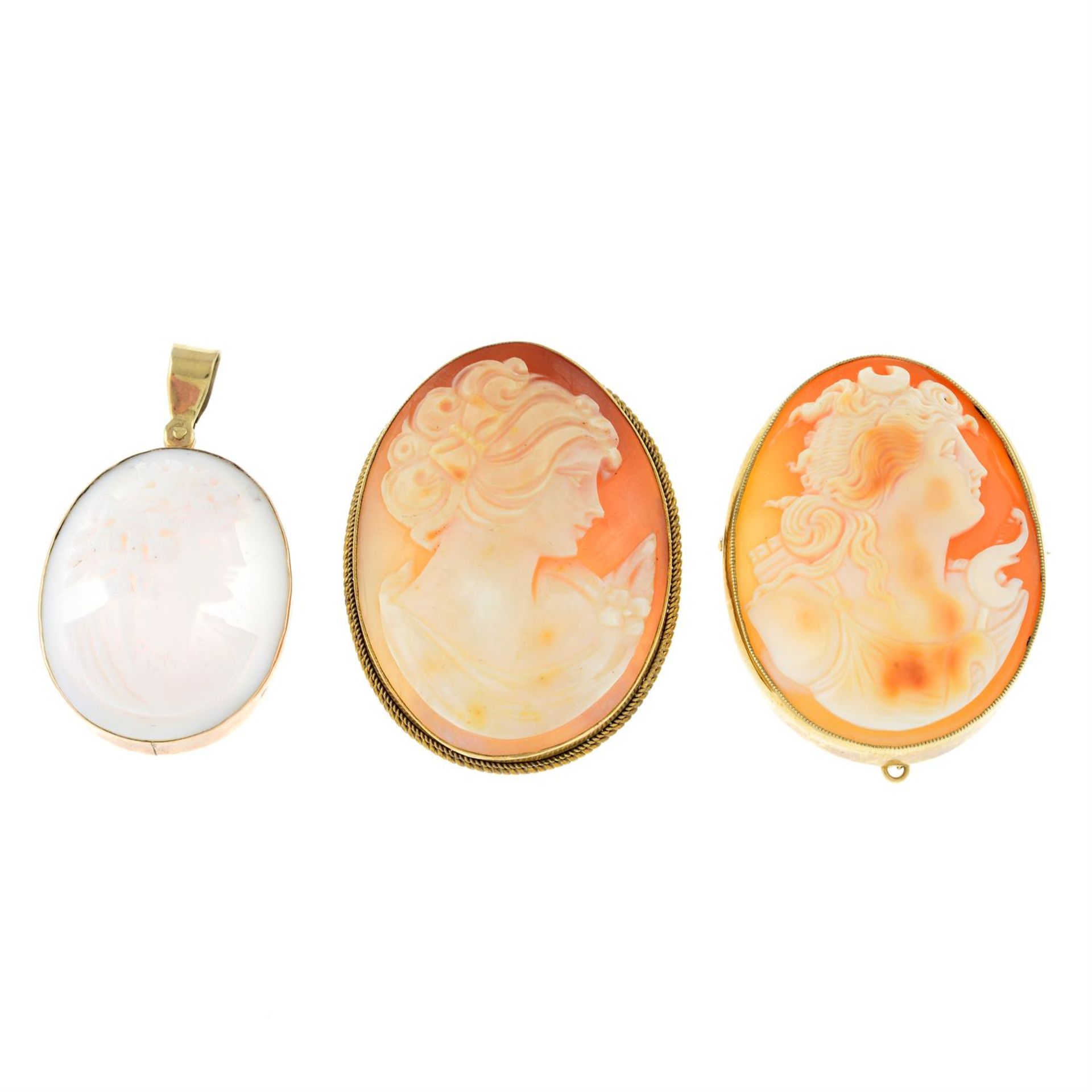 Two shell cameo brooches and a conch shell cameo pendant.