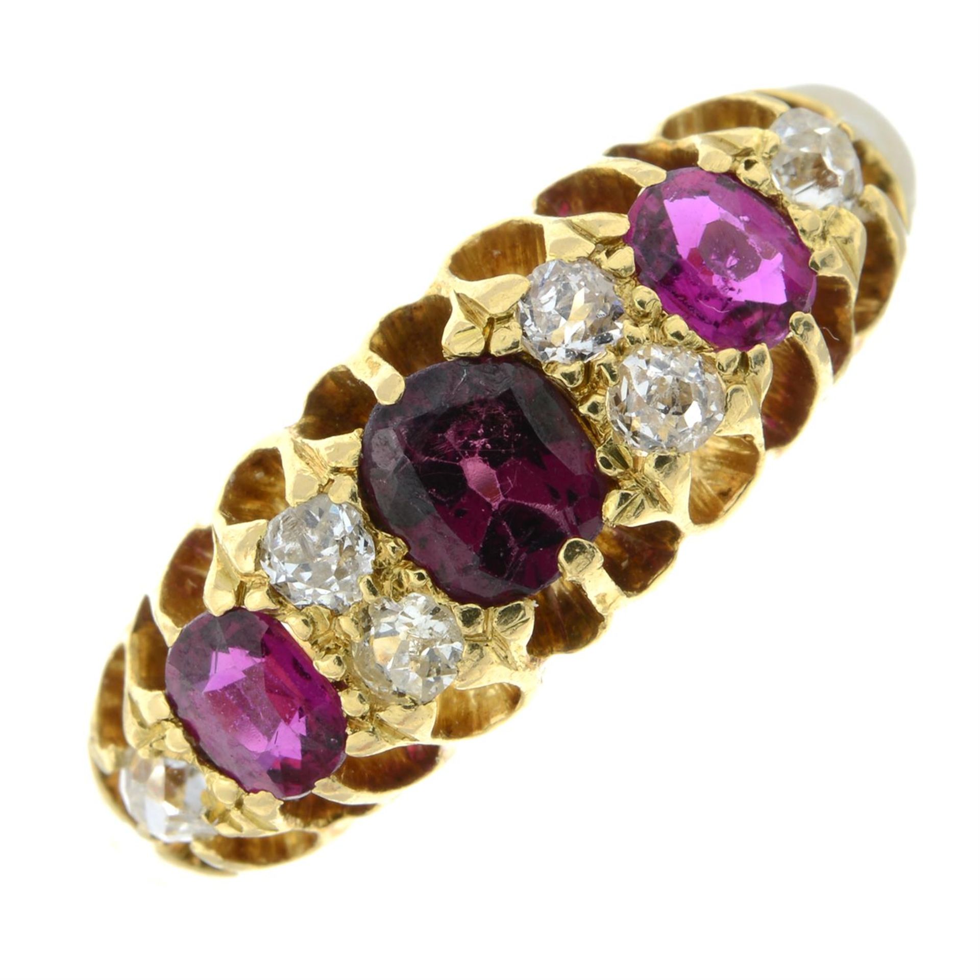 An Edwardian 18ct gold garnet and ruby three-stone ring, with old-cut diamond spacers.