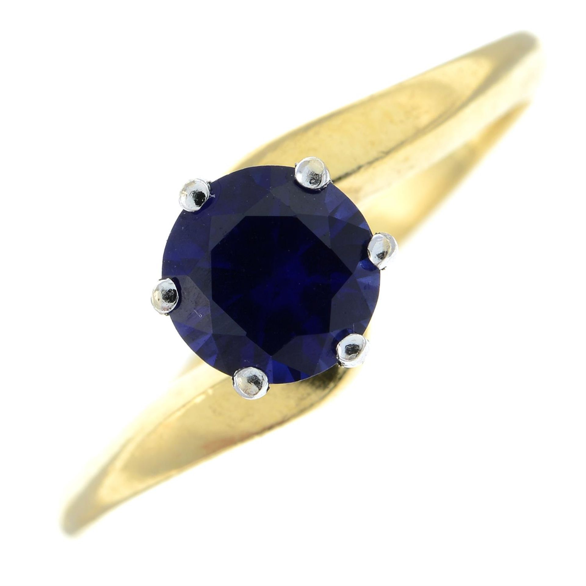 An 18ct gold synthetic sapphire single-stone ring.