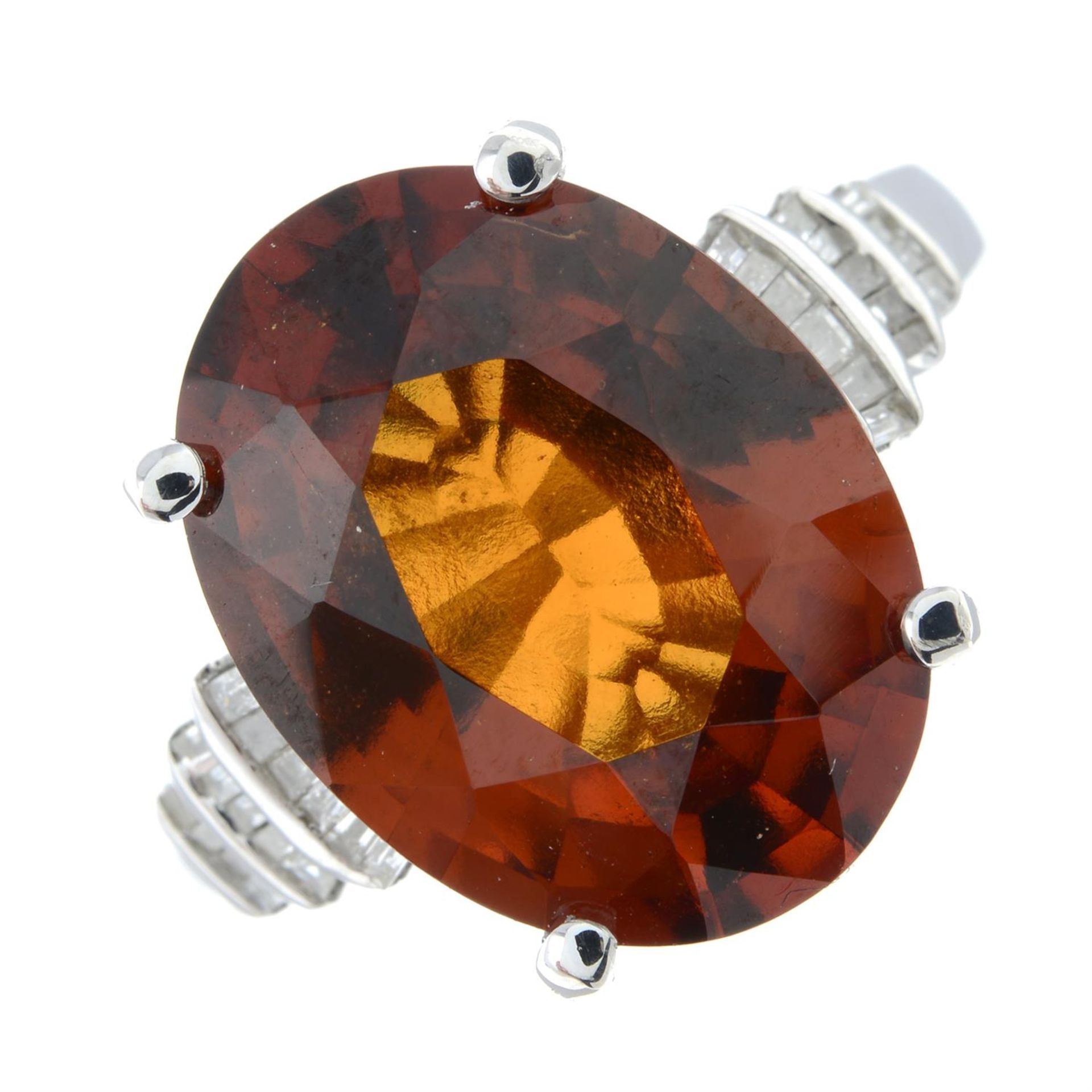 A hessonite garnet and diamond dress ring.