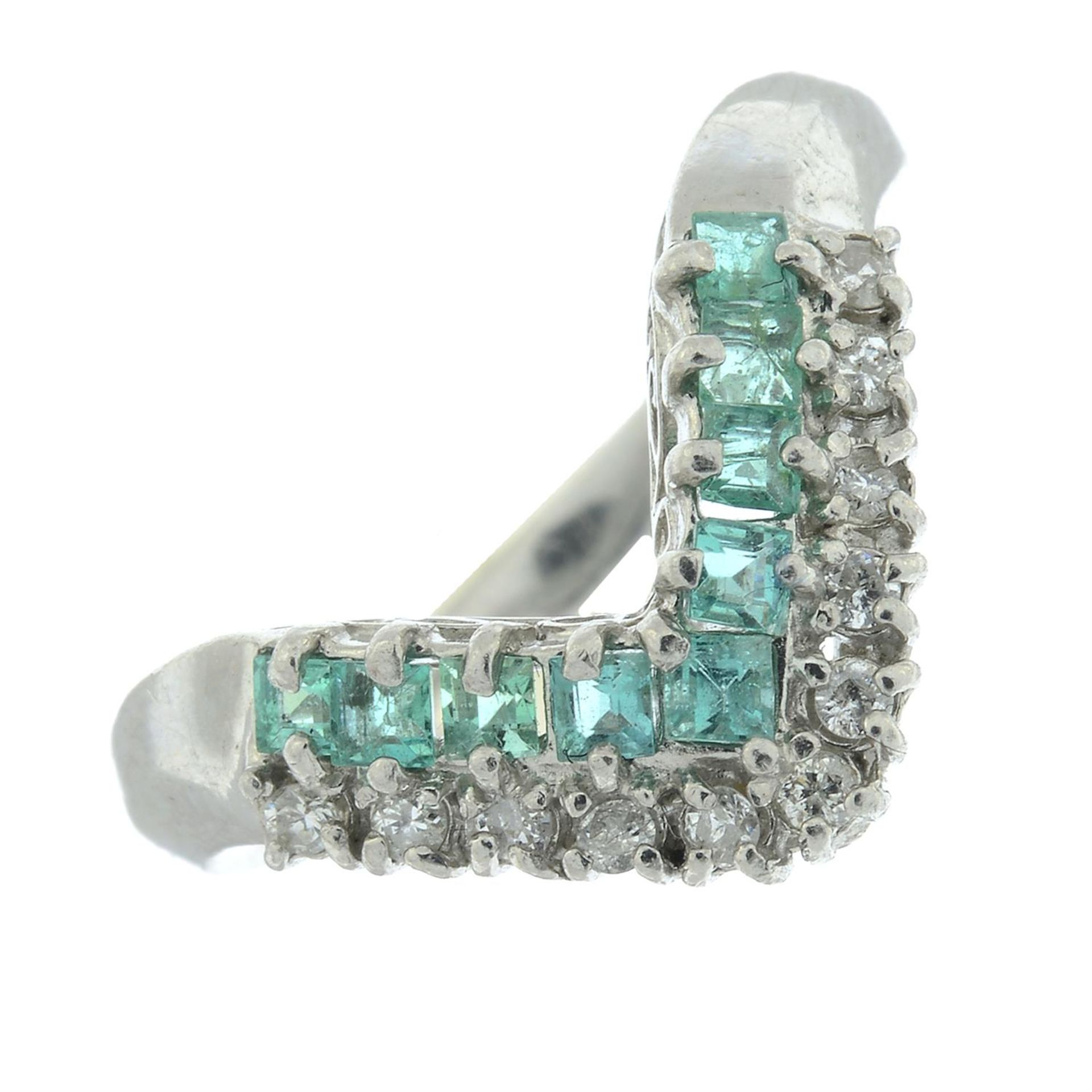 An emerald and diamond shaped ring.