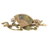 An early 20th century gold, gold-bearing quartz fan brooch, with foliate detail.