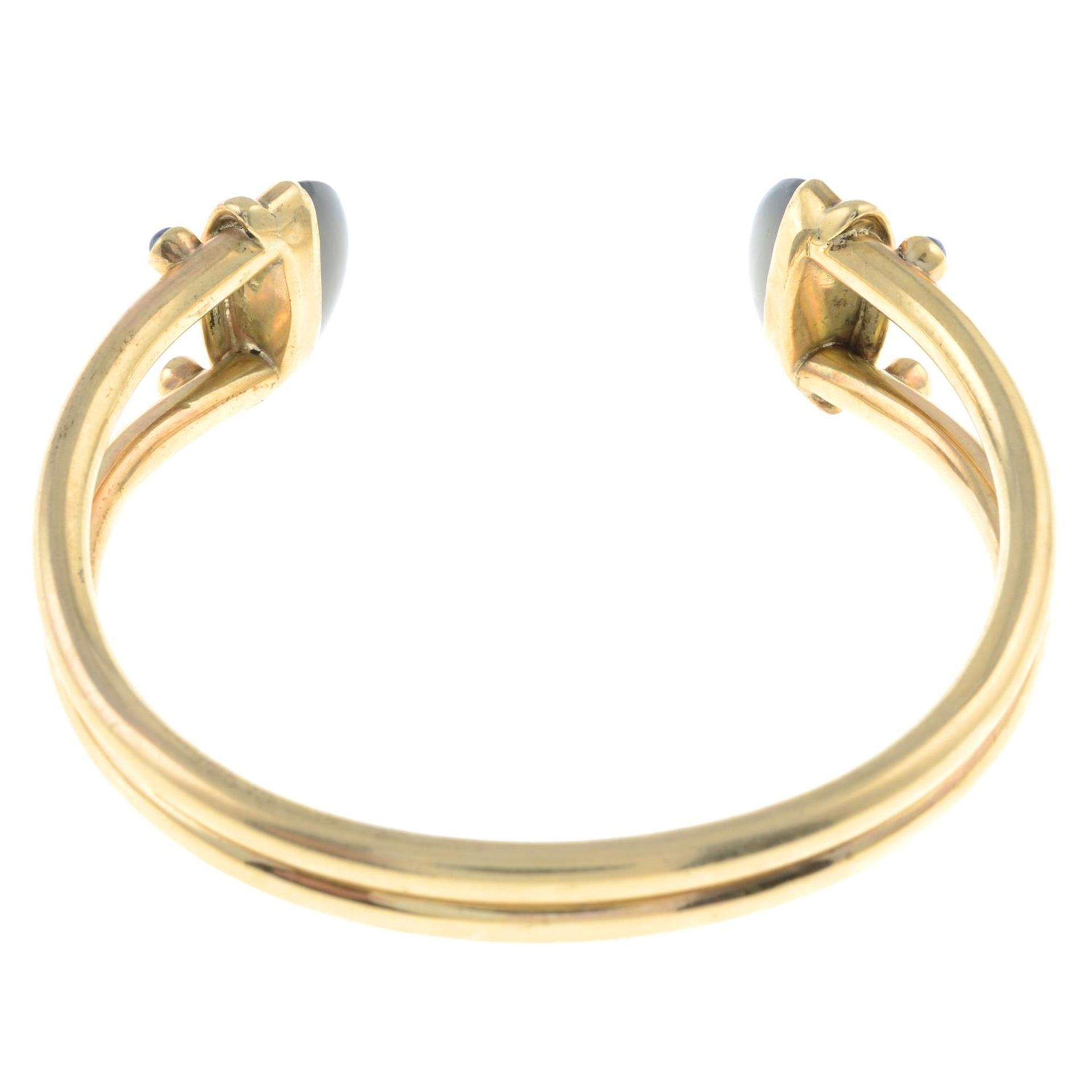 A 9ct gold cuff bangle, with sapphire and moonstone terminals. - Image 2 of 2