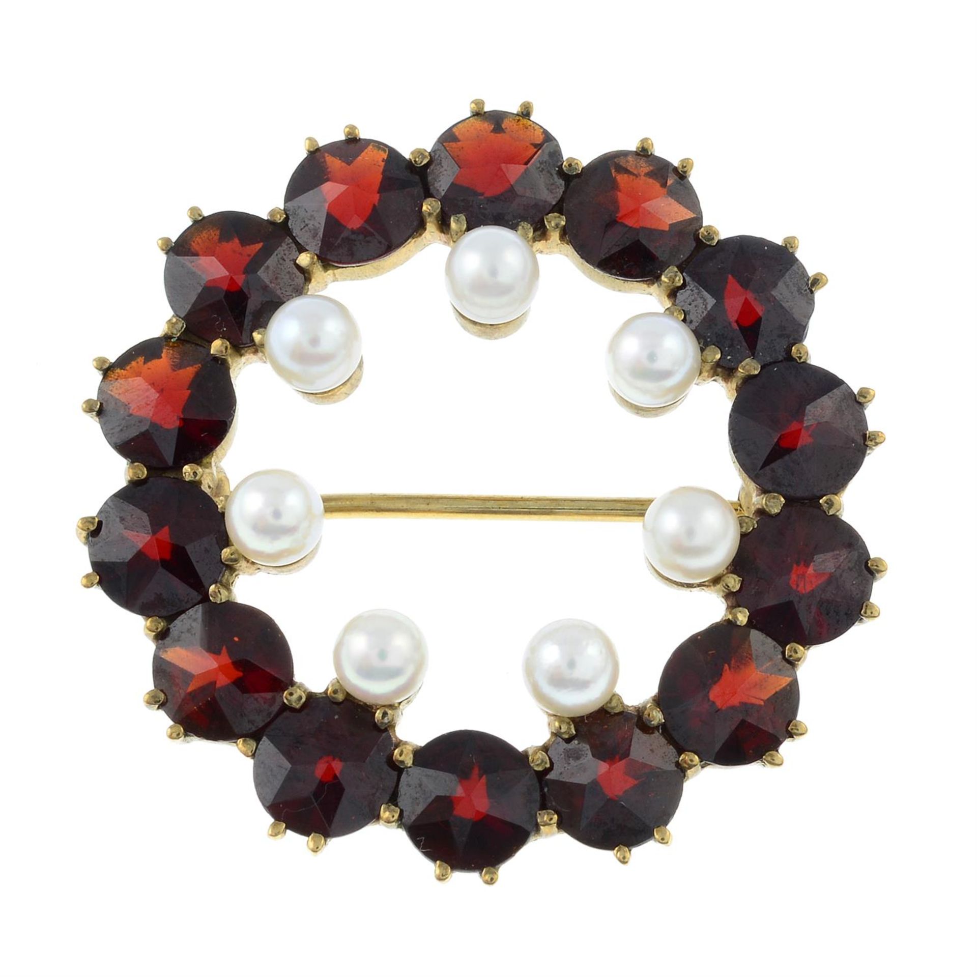 A garnet and seed pearl wreath brooch.