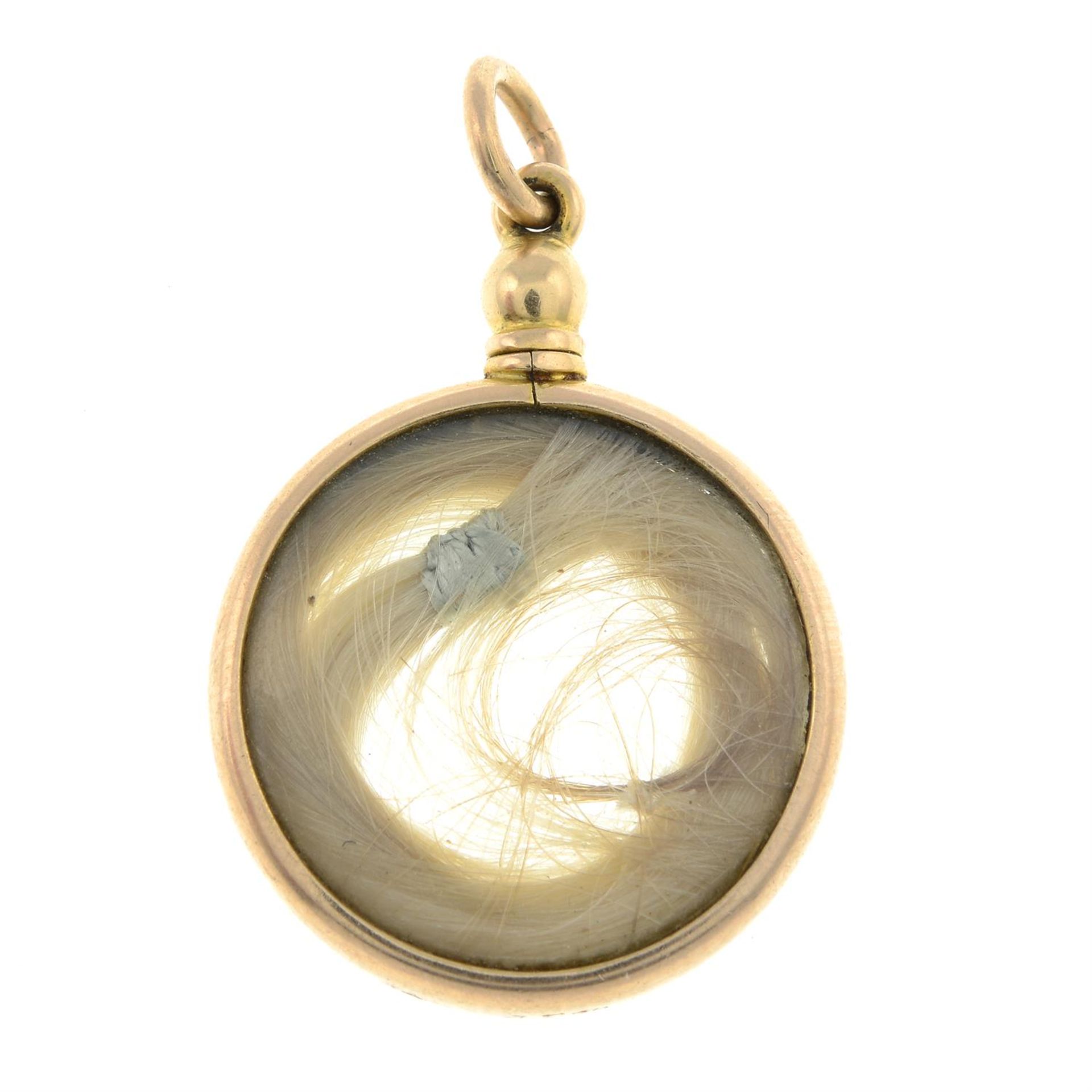 An early 20th century 15ct gold locket, containing a lock of hair.