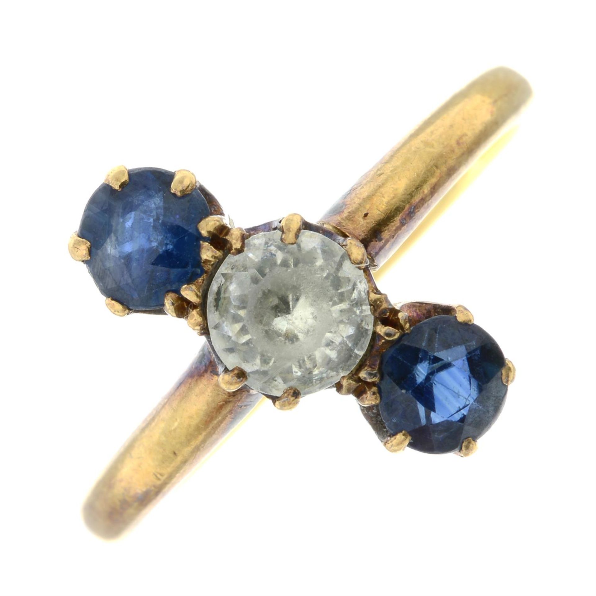 A colourless paste and sapphire three-stone ring.