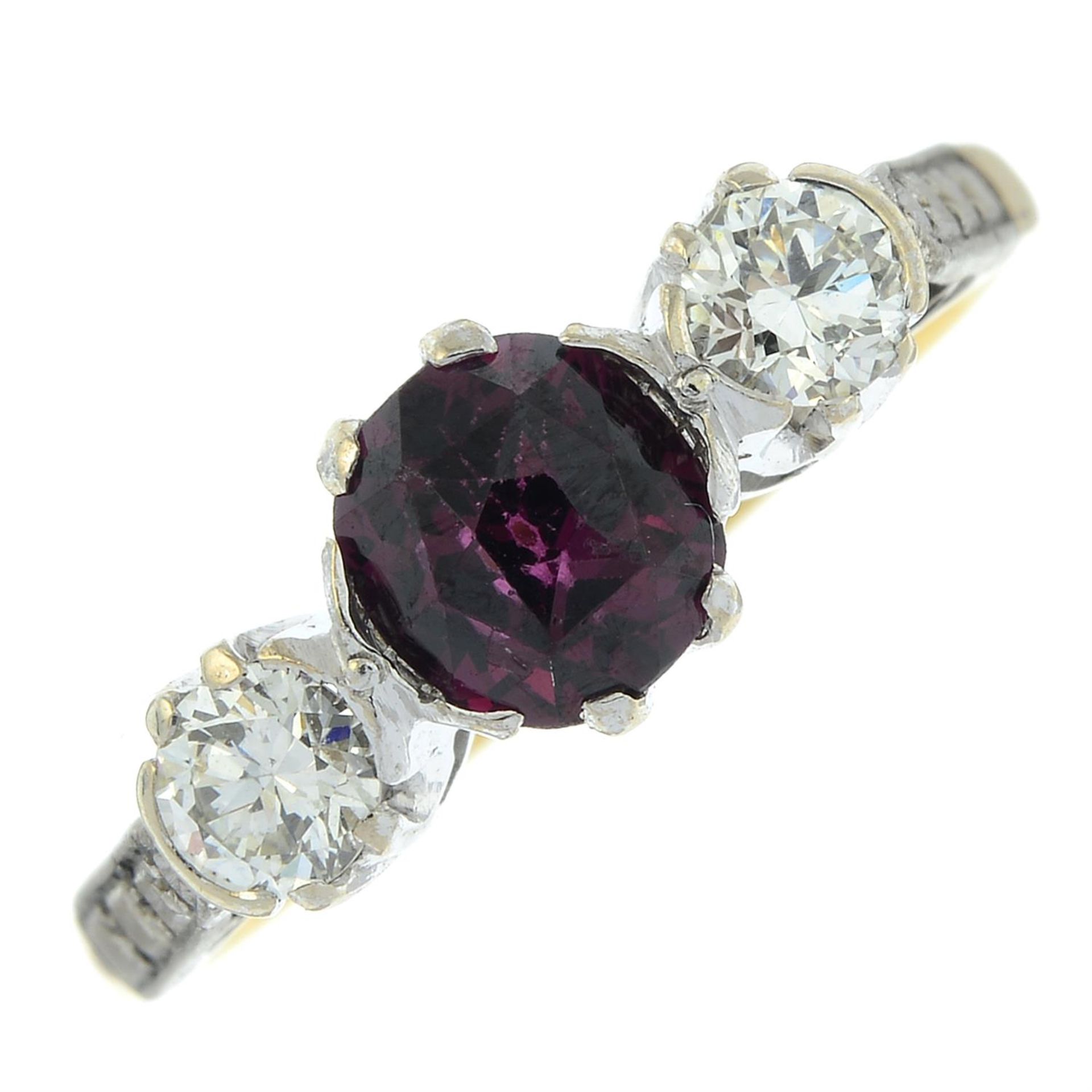 A garnet and brilliant-cut diamond three-stone ring.