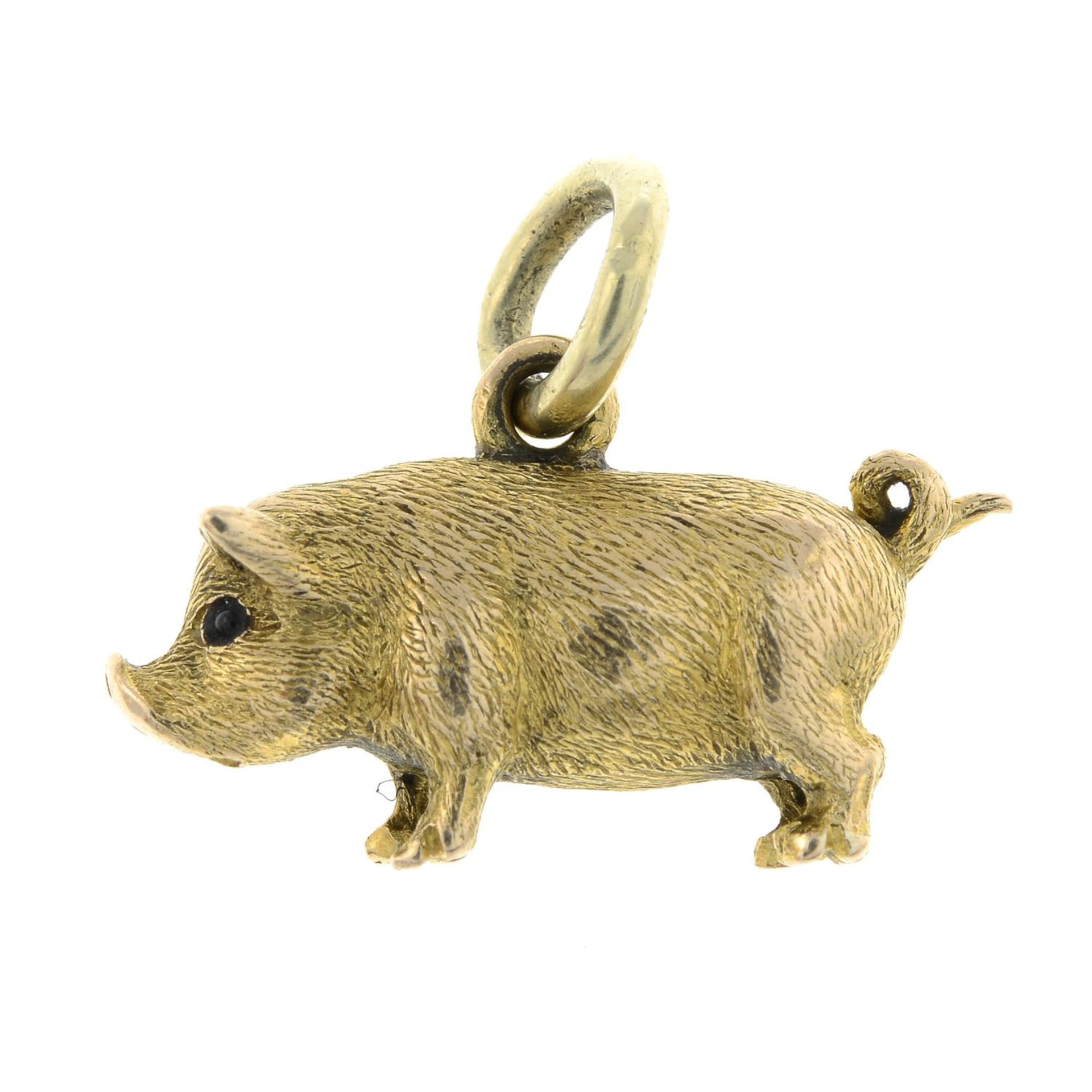 A late 19th century 18ct gold pig charm/ pendant, with ruby cabochon eyes.