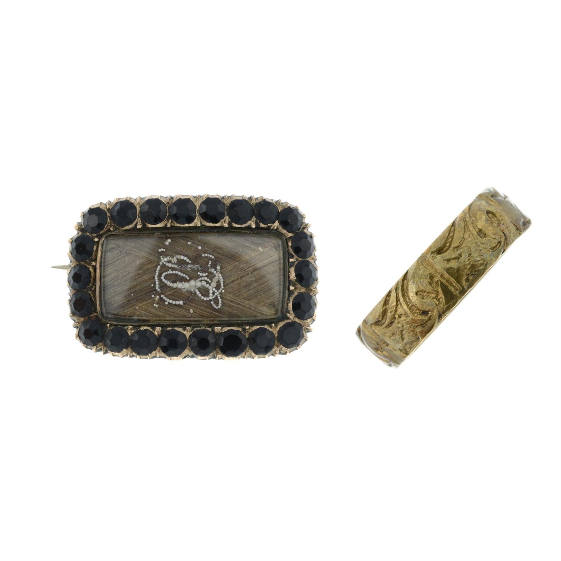 A Georgian seed pearl and onyx memorial brooch and a band ring.