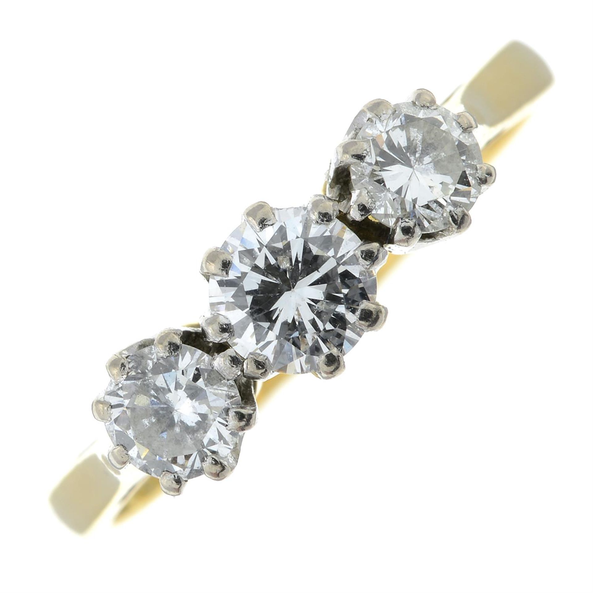 An 18ct gold brilliant-cut diamond three-stone ring.