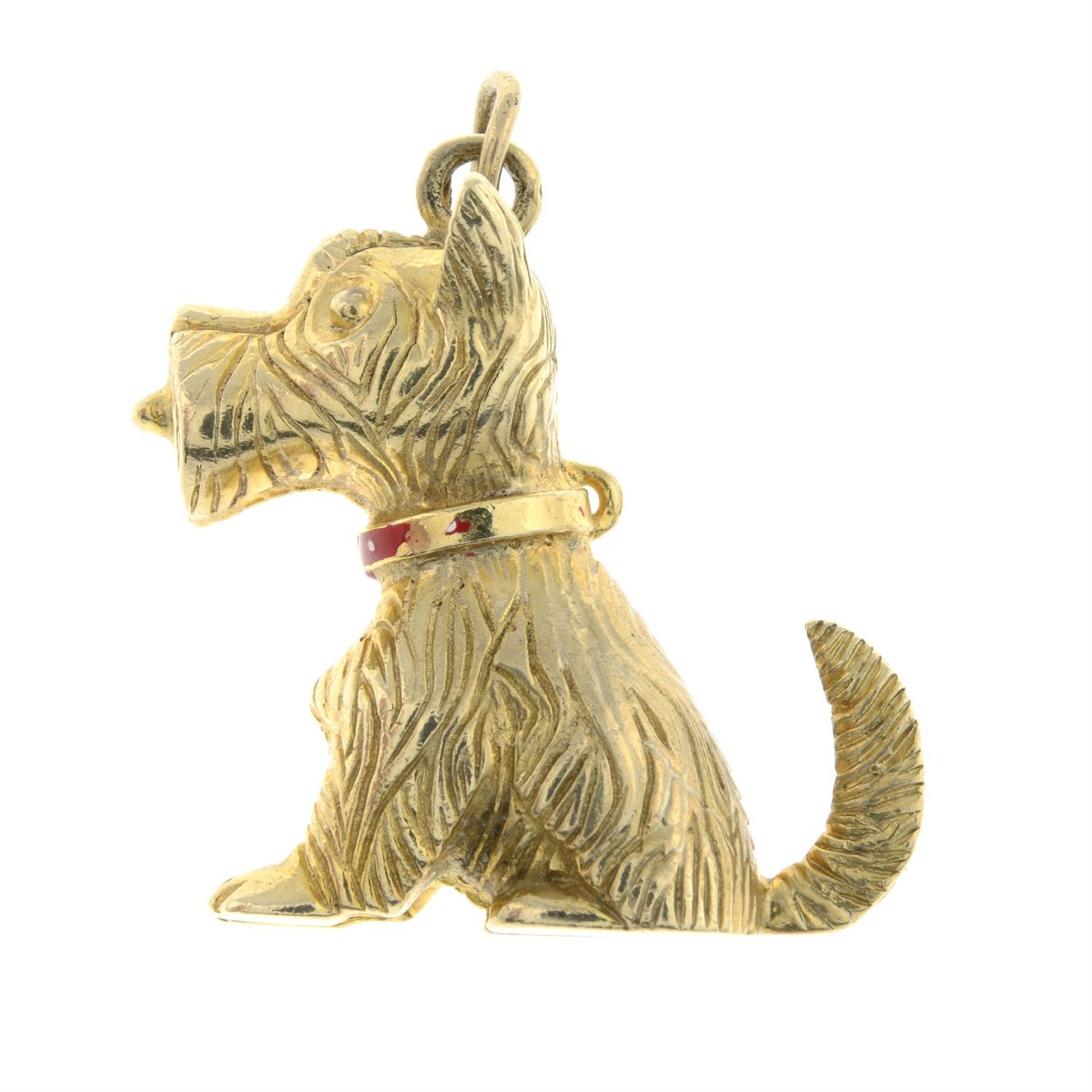 A 9ct gold textured dog charm, with red enamel collar and tongue.