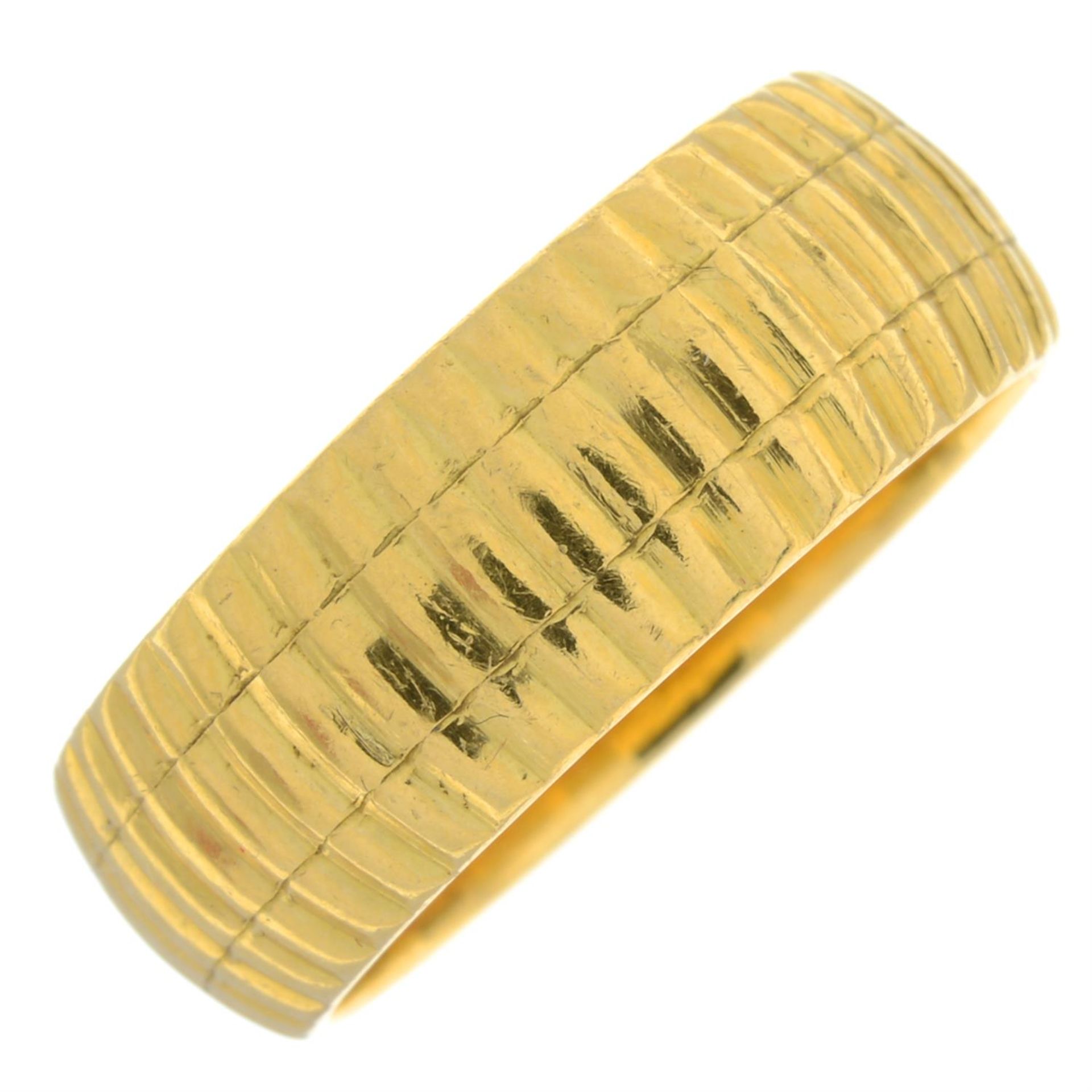 A 22ct gold textured band ring.