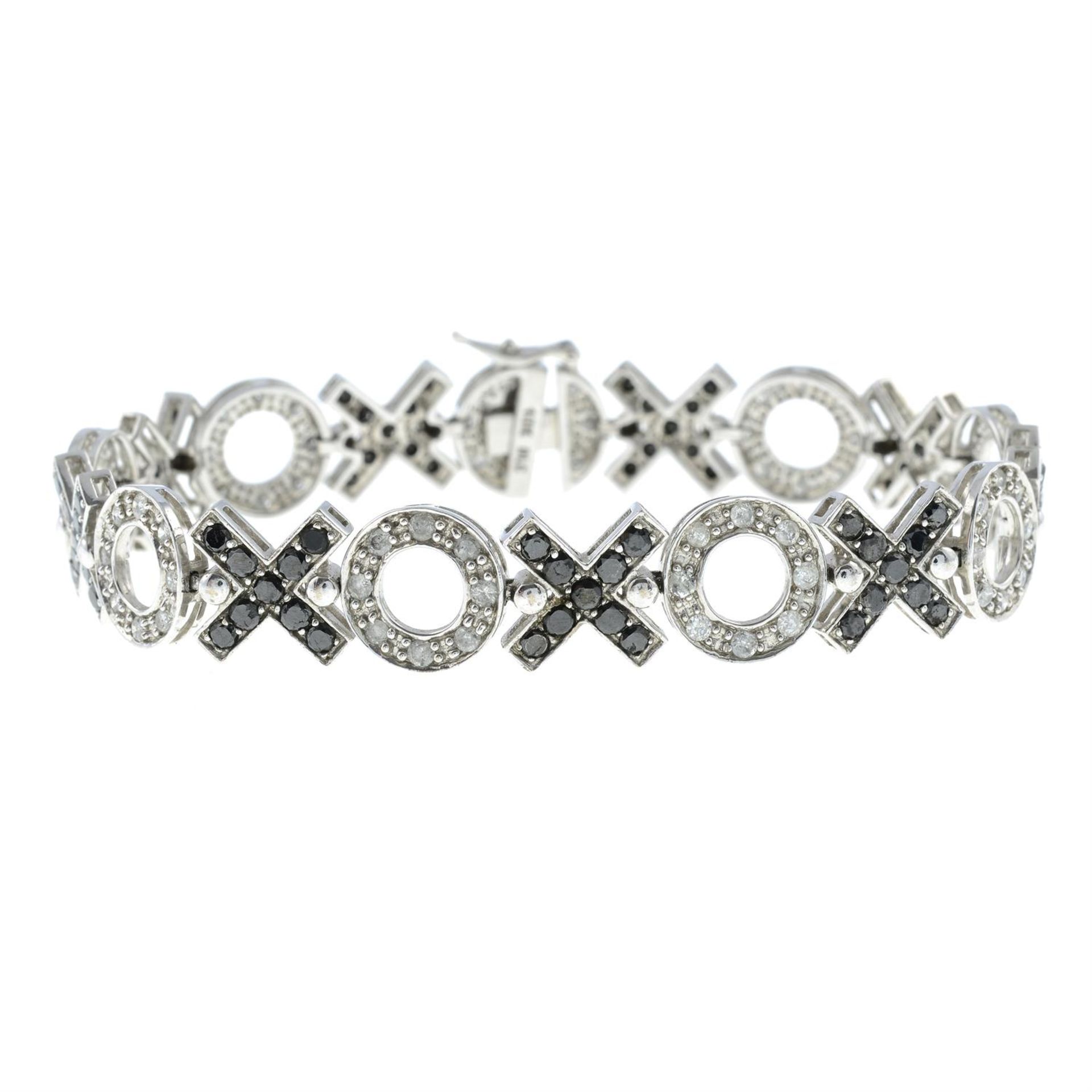 A diamond and black gem fancy-link bracelet.