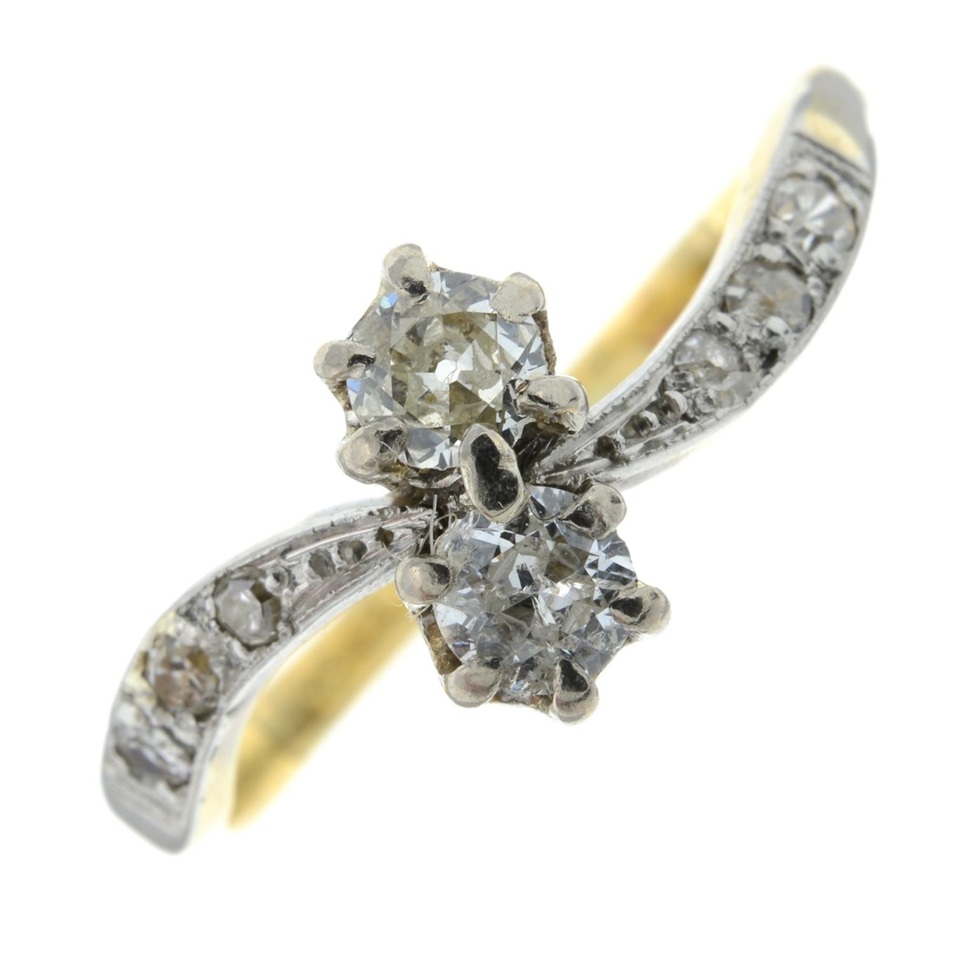 A diamond two-stone crossover ring, with diamond shoulders.