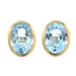 A pair of blue topaz earrings.